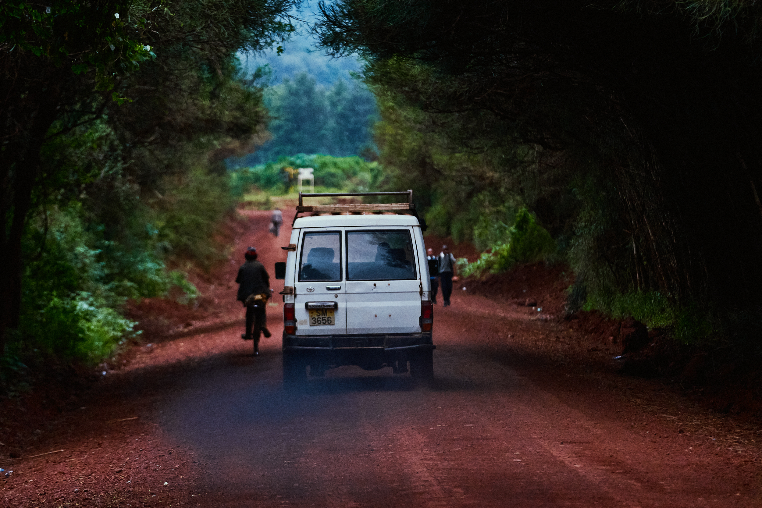 White van on red dirt road