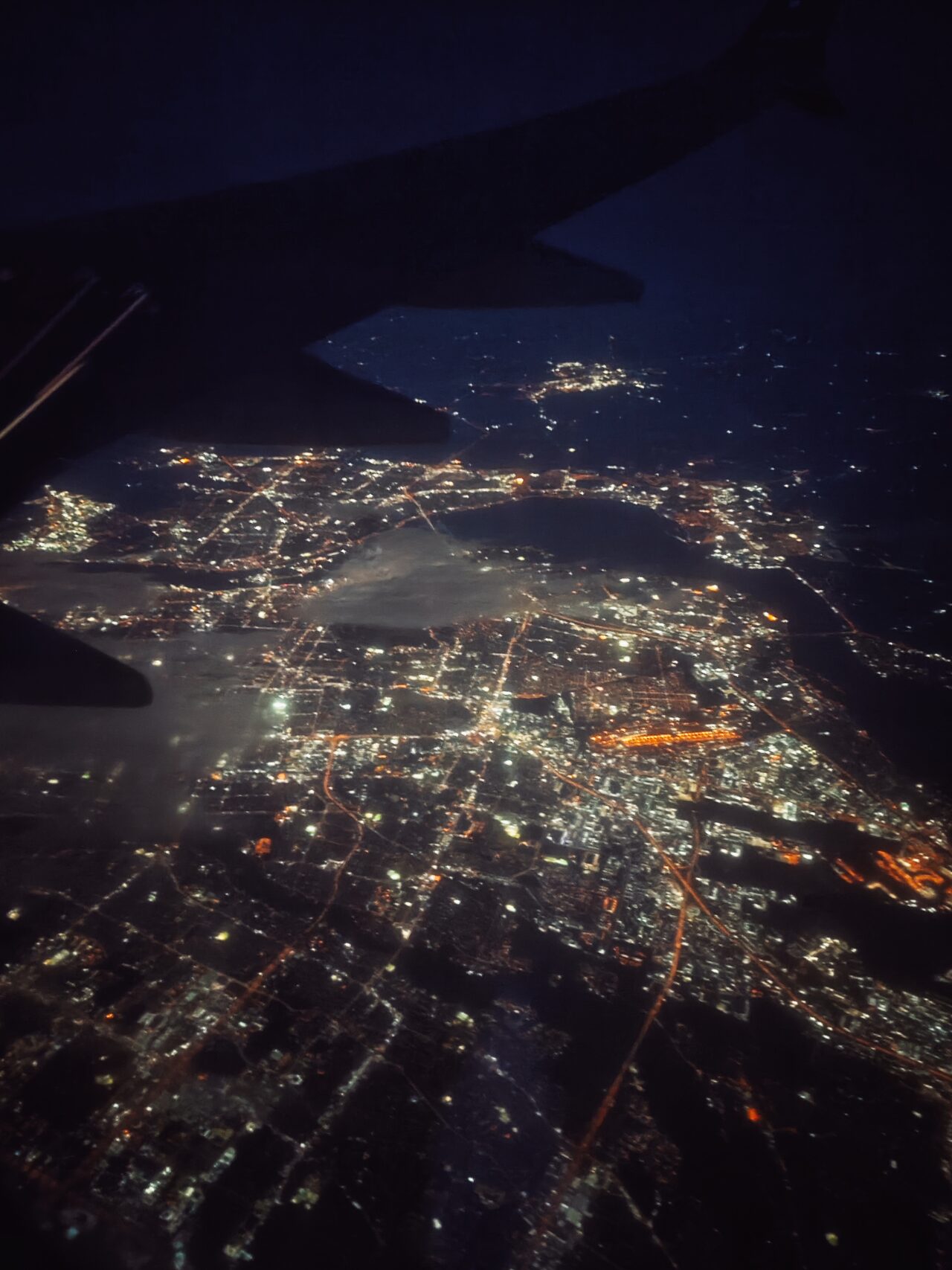 American city at night from plane