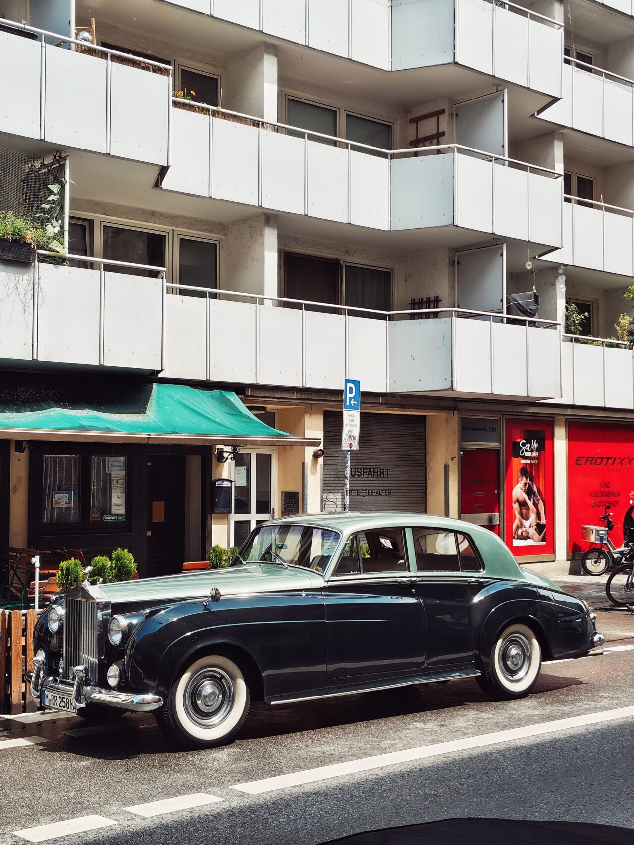 Rolls-Royce in front of adult store