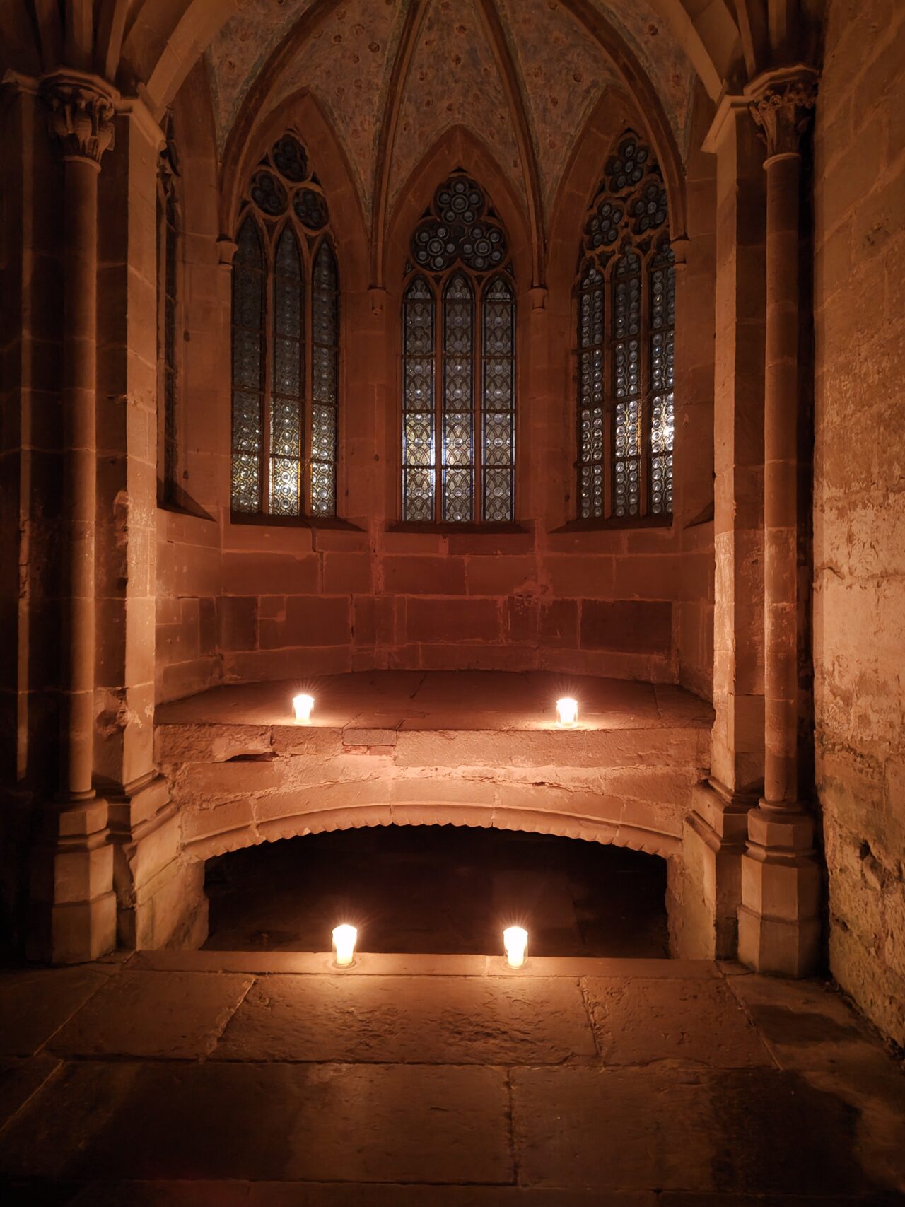 Cloister at night illuminated with candles