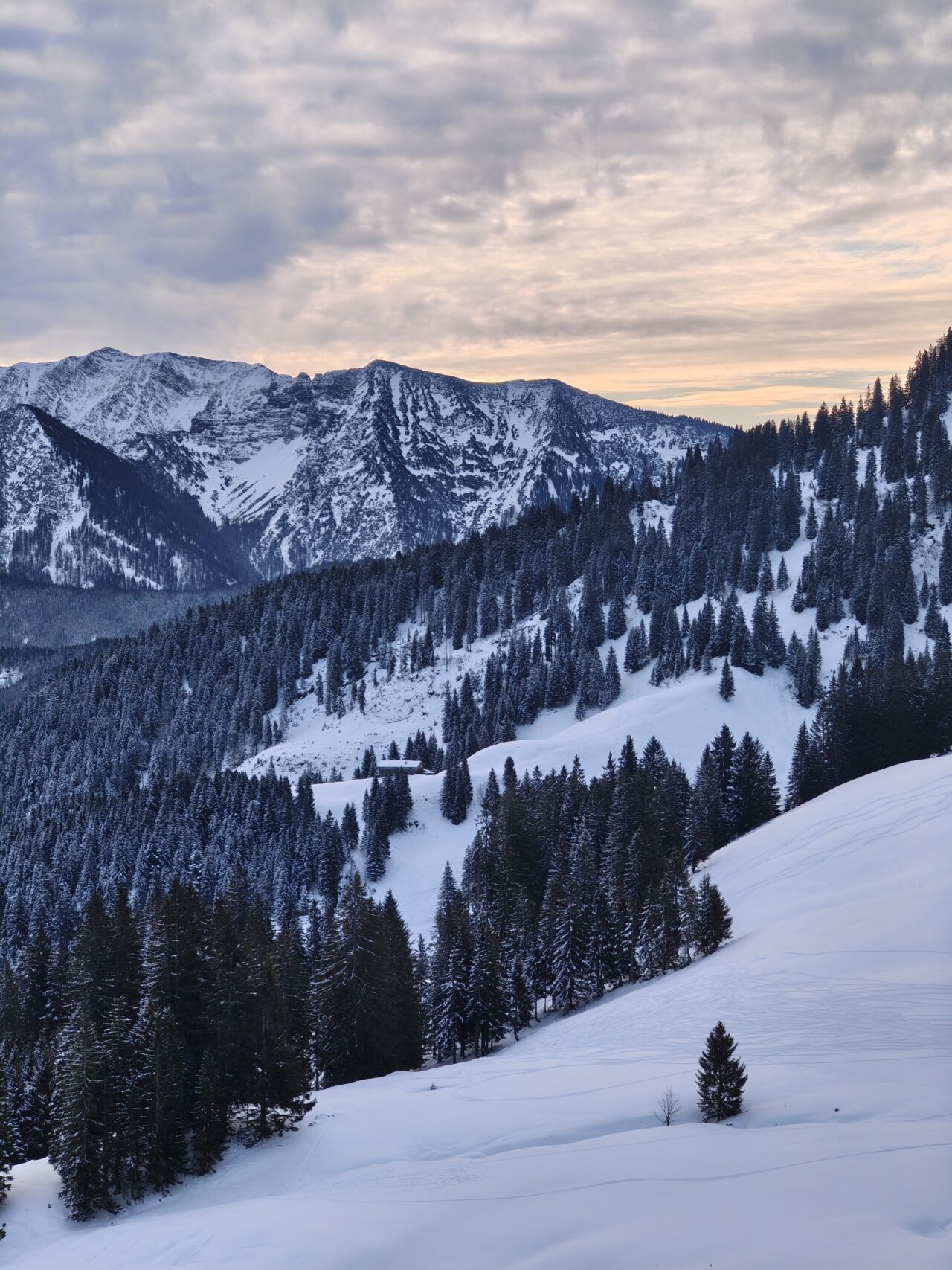Sunset over Bavarian mountains covered is snow